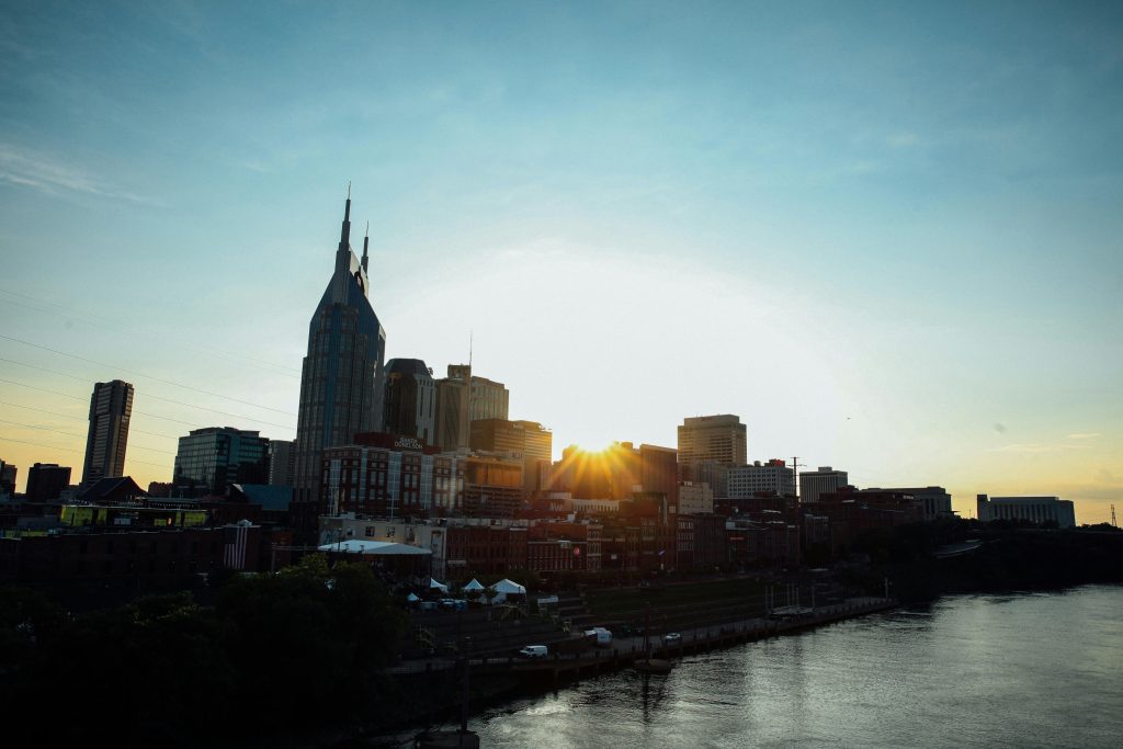 Nashville skyline featuring iconic downtown buildings under a clear blue sky.